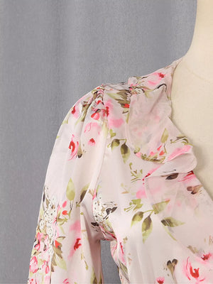 Charming ruffled floral mini dress with pink roses and green leaves on a light pink sheer fabric.
