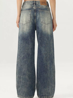 Men's vintage-inspired wide-leg jeans in distressed blue denim with a baggy fit.