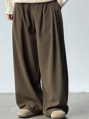 Men's dark brown wide leg casual sweatpants with pleats and a relaxed fit.