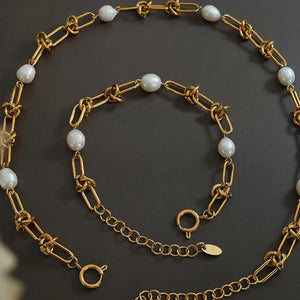 Gold linked pearl knot collar necklace with toggle clasp and extender chain.