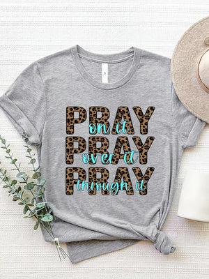 Gray graphic tee with leopard print text that reads "PRAY on it PRAY over it PRAY through it