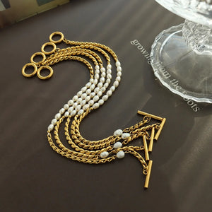 Gold cascading pearl and chain bracelet with toggle clasp