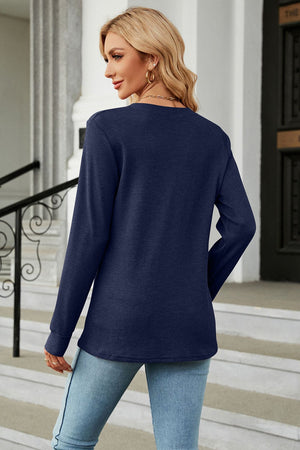 Dark blue waffle knit long sleeve top with crew neck, styled with jeans.