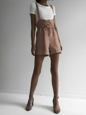 Dusty Pink high-waisted drawstring suspender shorts with pockets, styled with a white t-shirt.