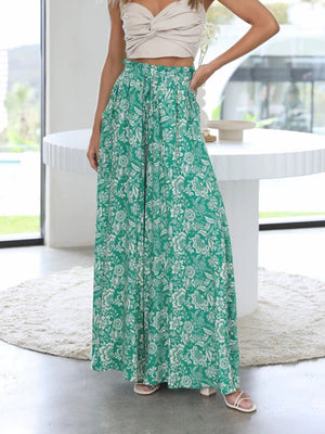 Green palazzo trousers with white floral print and ruffled waist