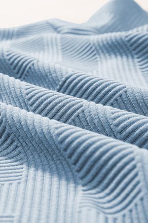 Light blue textured knit culottes with a subtle geometric pattern detail.