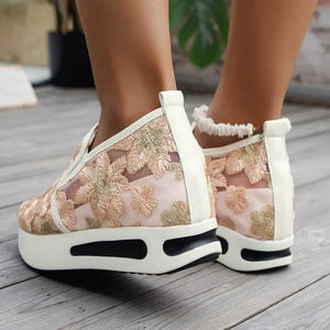 Pink floral embroidered mesh slip-on sneakers with white platform sole.