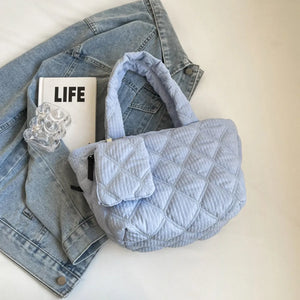 Quilted shopper bag in light blue with diamond pattern and front pocket.