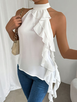 White halter neck blouse with cascading ruffles and a mock neck.