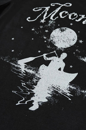 Black oversized tee with white graphic of a person kayaking under a moon and stars.