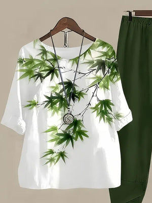 White half sleeve top with green bamboo print and matching green pants.