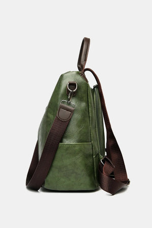 Dark green leather convertible backpack with brown straps and silver hardware.