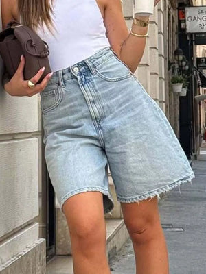 Light wash denim shorts with raw hem and high waist.