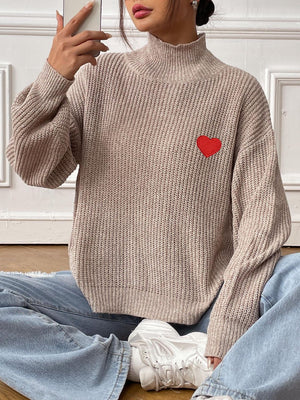 Khaki mock neck knit sweater with red heart appliqué, ribbed texture, and balloon sleeves.