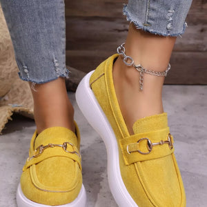 Yellow loafers with gold horse-bit detail and white platform sole.