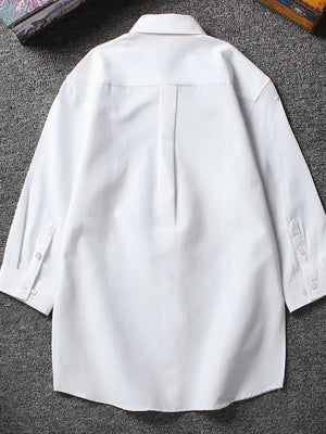 White button-up undershirt with 3/4 sleeves and buttoned cuffs.