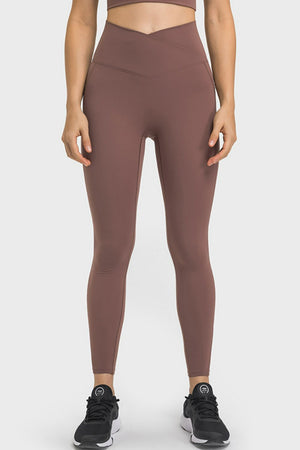 Brown performance leggings with sculpted waistband and pockets