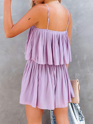 Lilac cami romper with delicate straps and tiered pleated design.