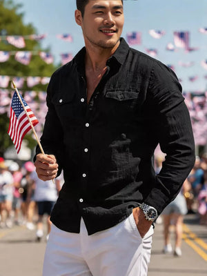 Black casual button-up shirt with two chest pockets and white buttons.