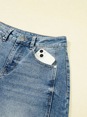 Vintage-inspired high-waisted seam jeans in light wash denim with a phone in the pocket.