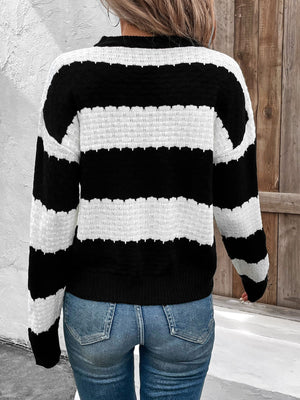 Black and white striped acrylic sweater with a round neck and textured knit details.