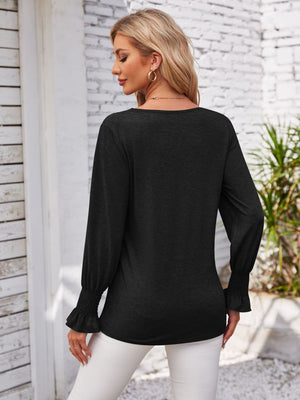 Black blouse with blouson sleeves and ruffled cuffs