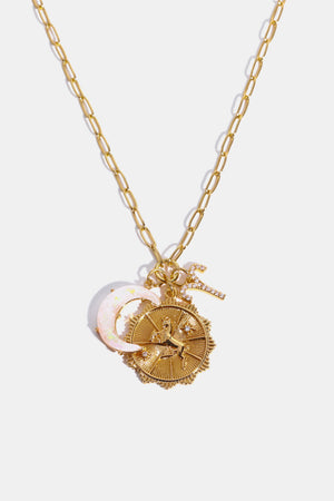 Gold celestial pendant necklace with moon, zodiac disc and diamond accent.