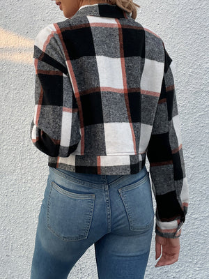 Checked plaid shacket with patch pockets in black, white, and rust.