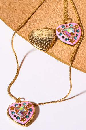 Gold locket heart pendant necklace with pink enamel, iridescent gem, blue crystals, and gold stars