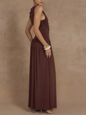 Brown ruched maxi dress with asymmetric neckline and sleeveless cut.