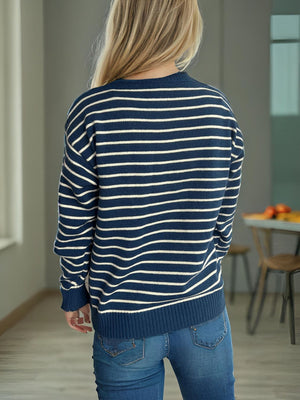 Dark Blue and White striped acrylic knit sweater with crew neck and long sleeves.