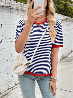 Striped knit tee with red trim and short sleeves, styled with a crossbody bag.