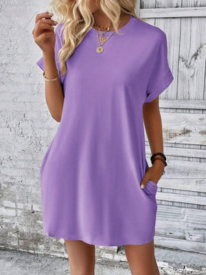 Relaxed tee dress in lavender with cuffed sleeves and pockets.