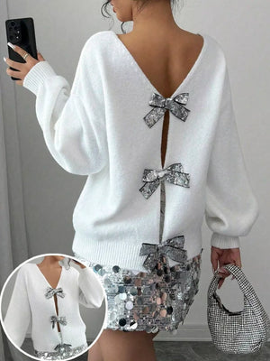 White knit cardigan with sequin bow details on the back and front closure.