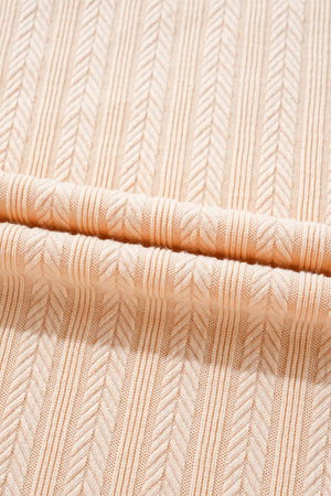 Textured ribbed sleeveless collar jumpsuit in eggshell with a chevron pattern.
