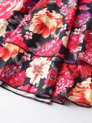 Floral ruffle hem mini dress in black with vibrant red, pink, and yellow blooms.