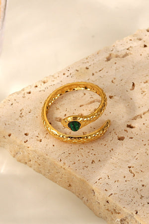 Gold serpentine ring with malachite accent, featuring a detailed coil design.