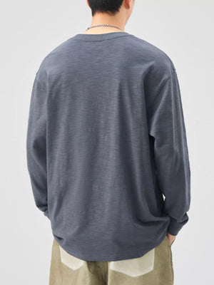 Oversized long-sleeve cotton tee in Space Gray, showing back view.