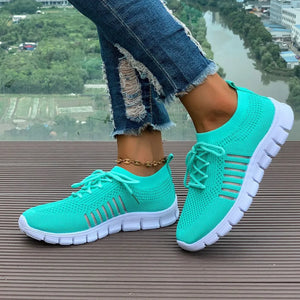 Aqua knit runner sneakers with white soles and stripe detail.