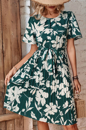 Forest green floral midi dress with flutter sleeves, pleated skirt, and belt