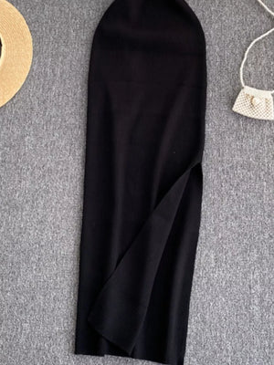 Black ribbed knit midi dress with a high slit and cutout detail.
