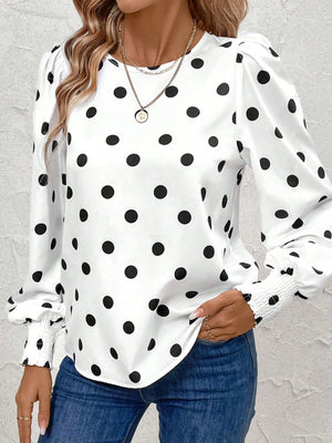 White polka dot blouse with smocked cuffs and puff sleeves