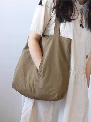 Spacious Khaki nylon shoulder bag with exterior slip pocket.