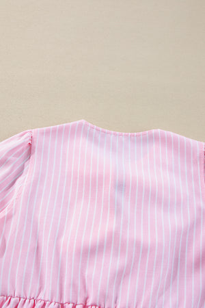 Blush pink striped peplum blouse with puff sleeves and ruffled hem detail.