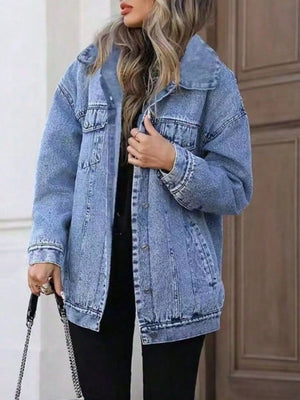 Oversized washed blue denim jacket with button front and chest pockets.