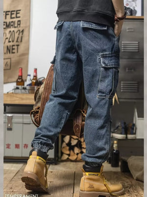 Men's vintage wash blue denim cargo jeans with elastic cuffs and multiple pockets.