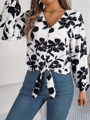 White floral knot-front blouse with ruffled cuffs and V-neck