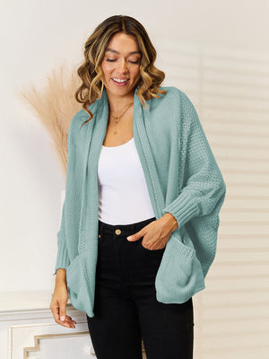 Teal acrylic knit cocoon cardigan with pockets and relaxed fit.