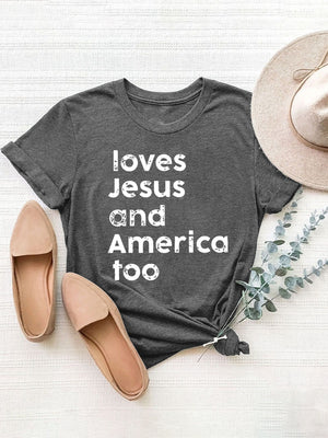 Dark gray crew neck tee with white "loves Jesus and America too" graphic.