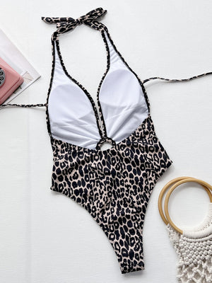Leopard print one-piece swimsuit with halter neck, ring detail, and plunging neckline.